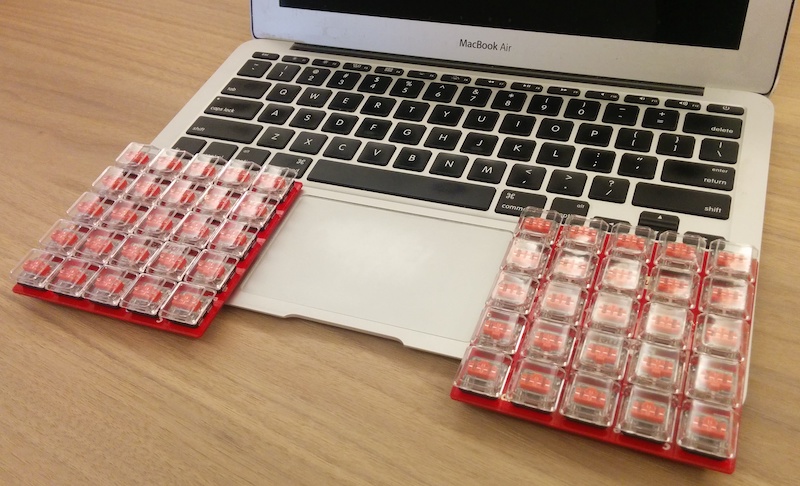 Two small keyboards on a macbook air