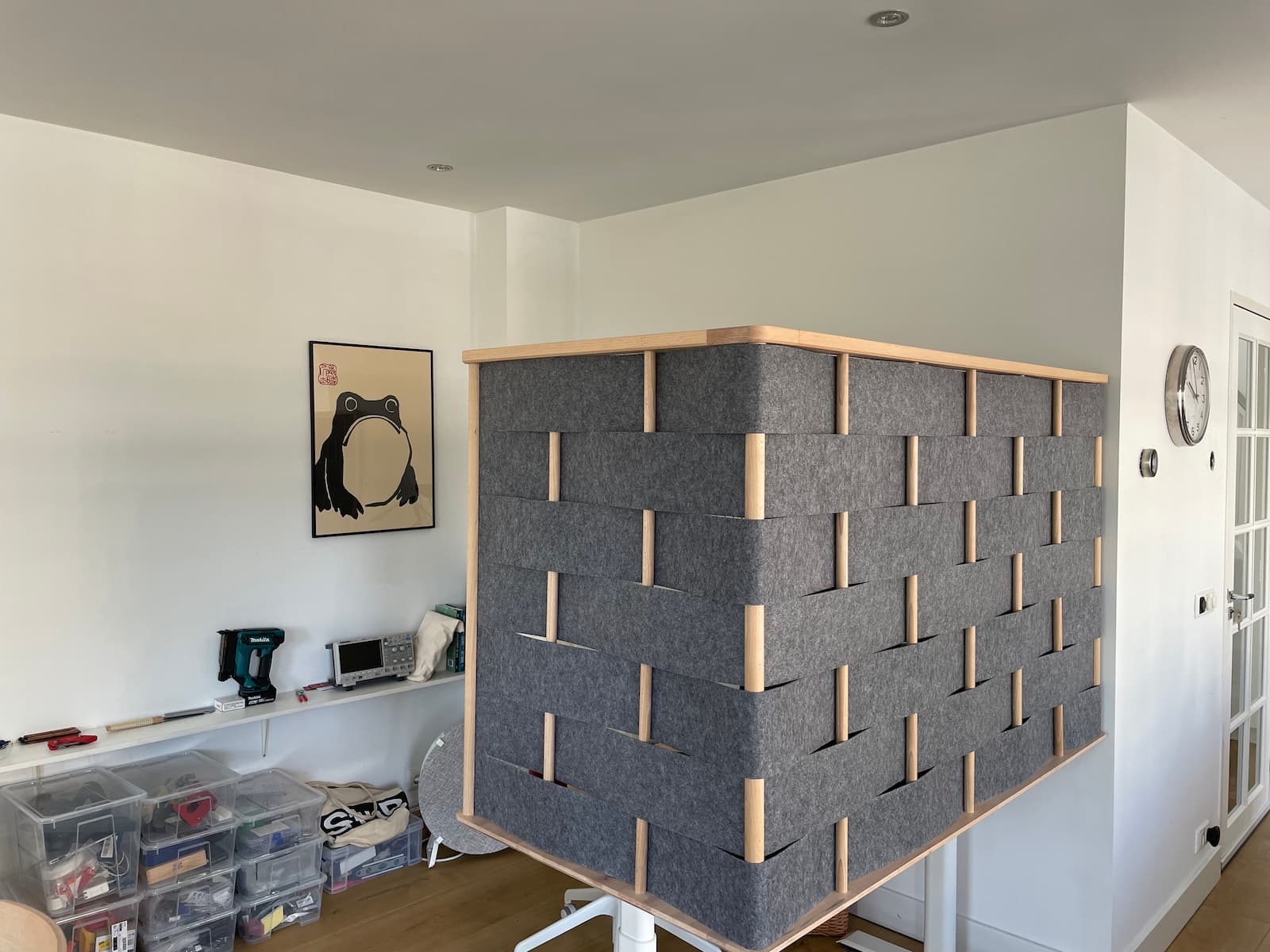 a standing desk with tall wood/felt partition